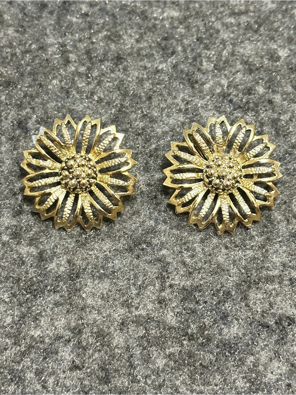 Vintage gold-tone clip-on earrings featuring a delicate filigree flower or daisy